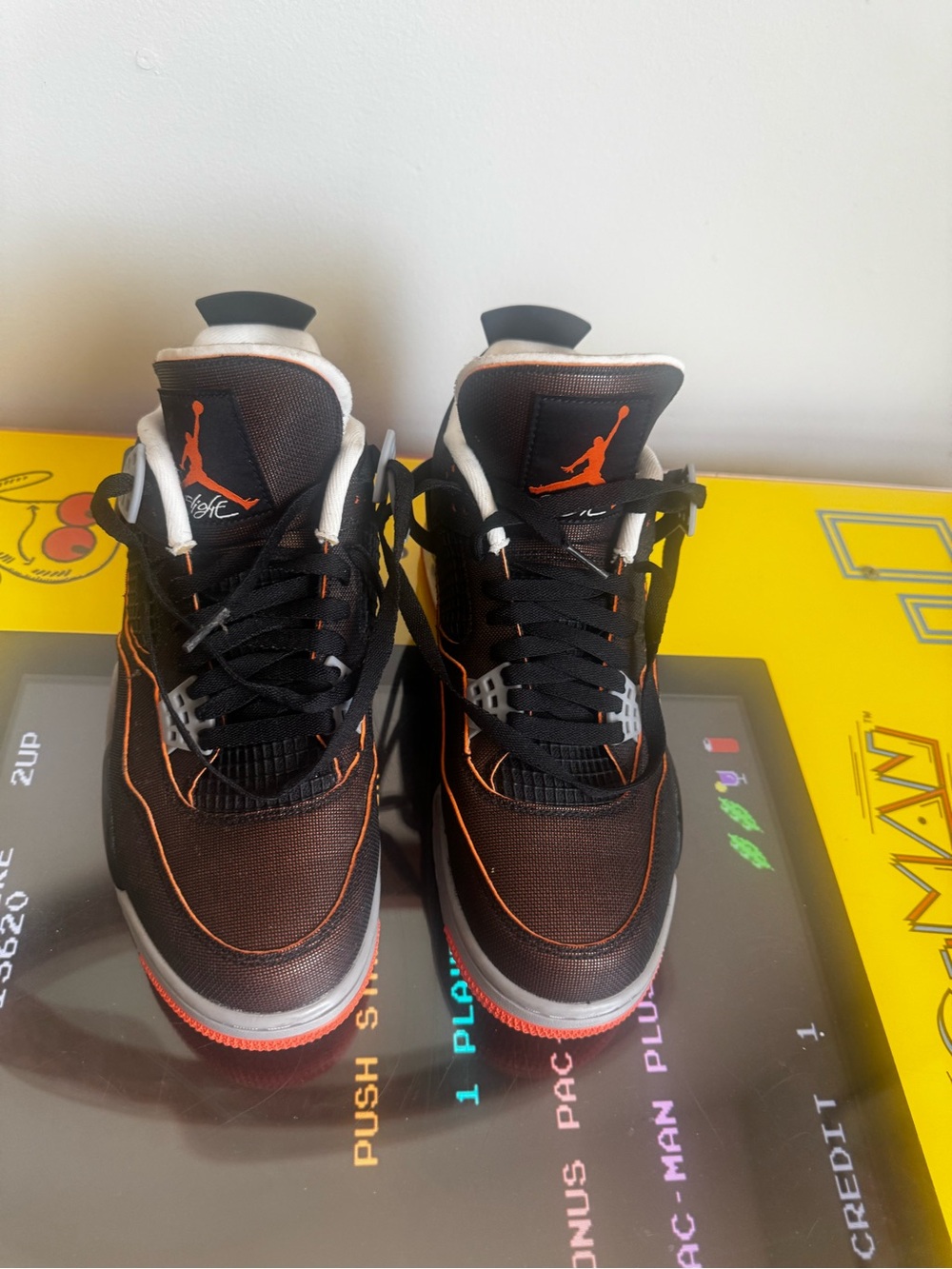 Nike Air Jordan 4 Retro women’s Starfish" sneakers in black and orange color way